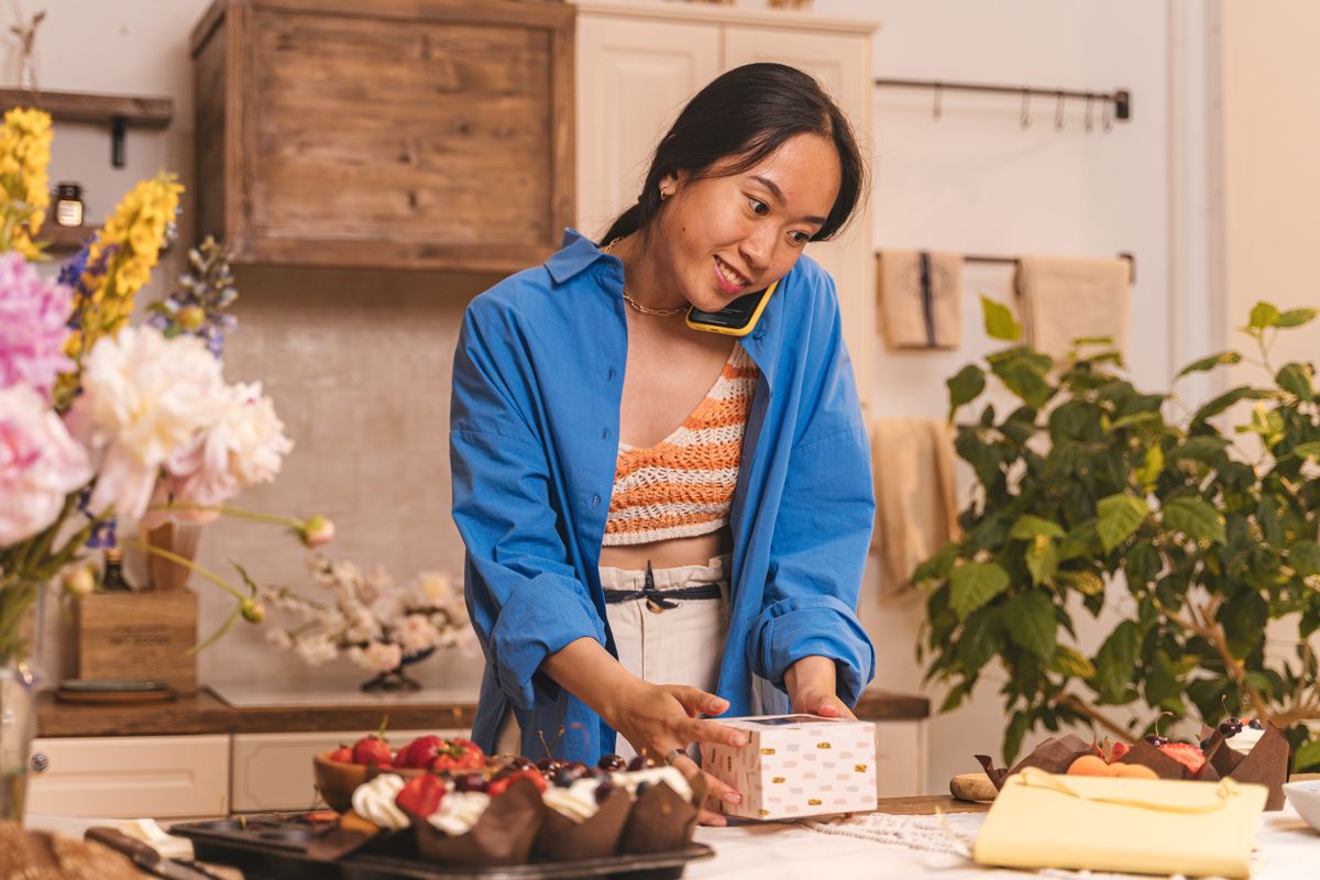 Bakery owner smiling while taking a phone call